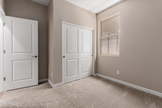 5656 N 205th Ln, Buckeye, AZ 85396 - unfurnished bedroom featuring carpet, baseboards, and a closet