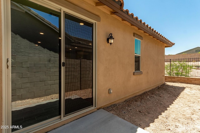 5656 N 205th Ln, Buckeye, AZ 85396 - view of exterior entry featuring stucco siding and a tiled roof