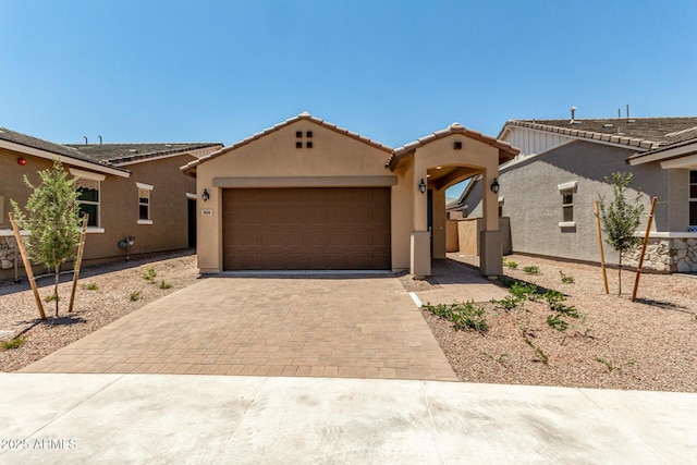 5656 N 205th Ln, Buckeye, AZ 85396 - view of front facade featuring decorative driveway, a garage, stucco siding, and a tile roof