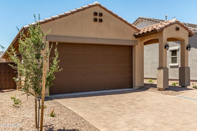 5656 N 205th Ln, Buckeye, AZ 85396 - view of front of house with a tile roof, stucco siding, an attached garage, and driveway