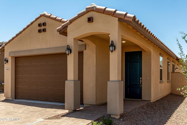 5656 N 205th Ln, Buckeye, AZ 85396 - view of front of home with a tiled roof, stucco siding, a garage, and decorative driveway