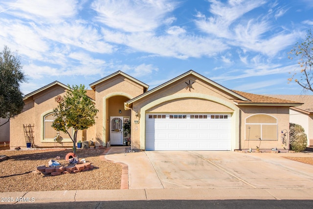 view of front of house with stucco siding, driveway, and an attached garage