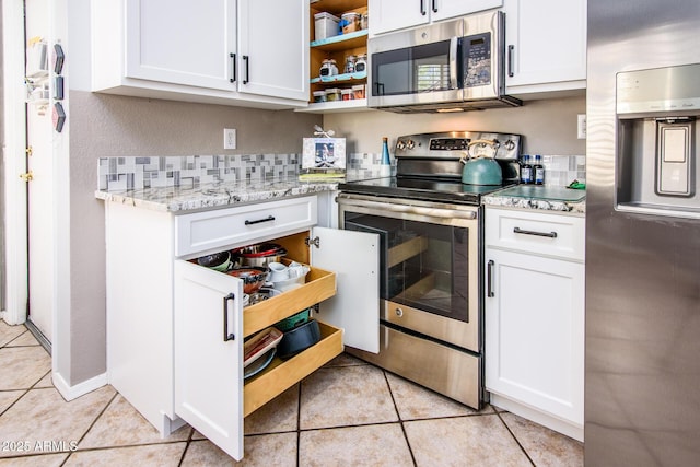 kitchen with light tile patterned floors, white cabinetry, stainless steel appliances, and open shelves