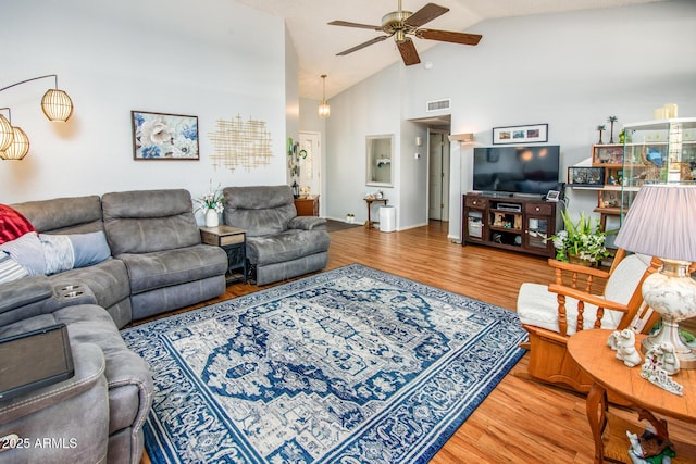 living area featuring high vaulted ceiling, wood finished floors, visible vents, and ceiling fan