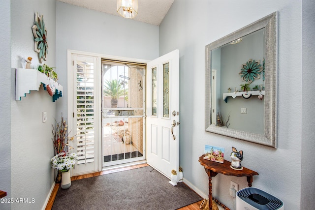 doorway to outside with baseboards