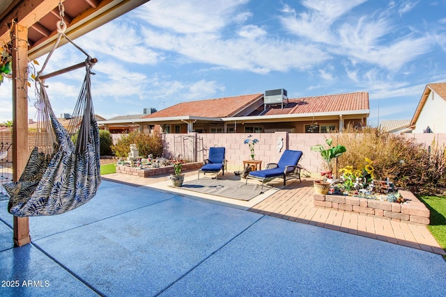 view of pool with cooling unit, a fenced backyard, and a patio area