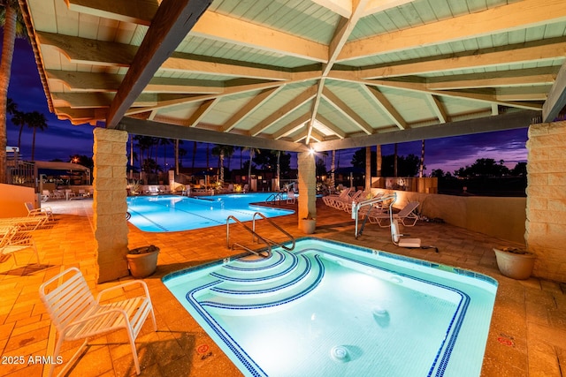 pool with a gazebo and a patio