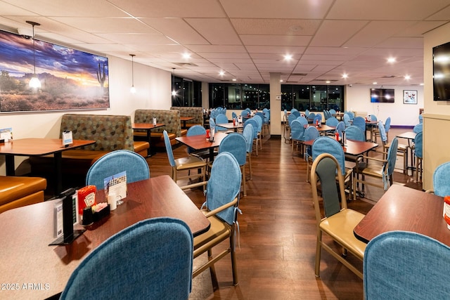 recreation room featuring a paneled ceiling and wood finished floors