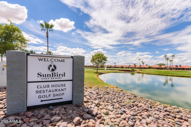 community sign with a water view