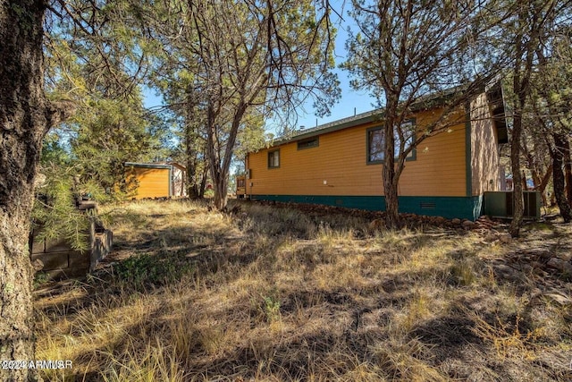 2086 Pinewood Dr, Overgaard, AZ 85933 - view of side of property with crawl space and central air condition unit