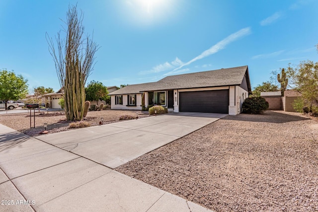 single story home featuring a garage and concrete driveway