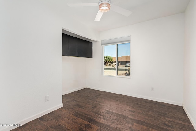 spare room with ceiling fan, baseboards, and wood finished floors