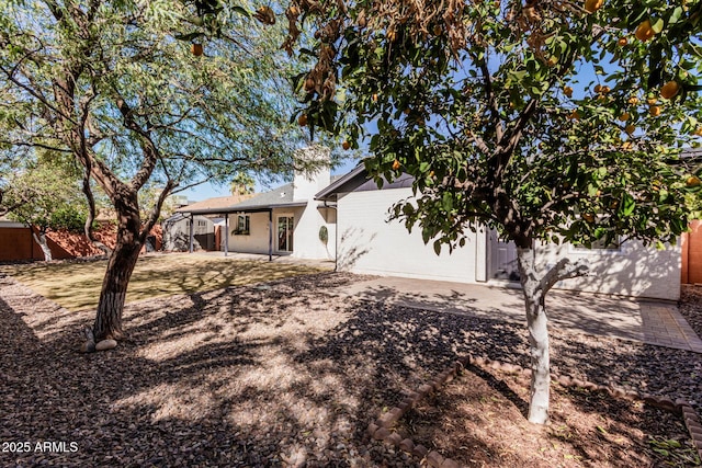 rear view of property with fence