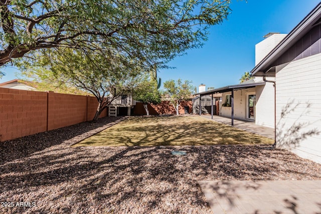 view of yard with a patio area and a fenced backyard