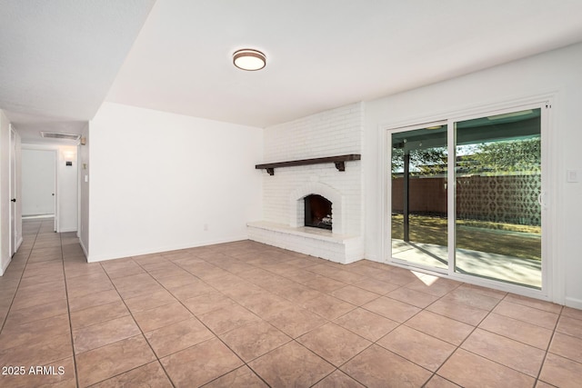 unfurnished living room featuring light tile patterned floors, visible vents, a fireplace, and baseboards