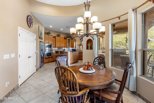 dining area with a notable chandelier and light tile patterned flooring