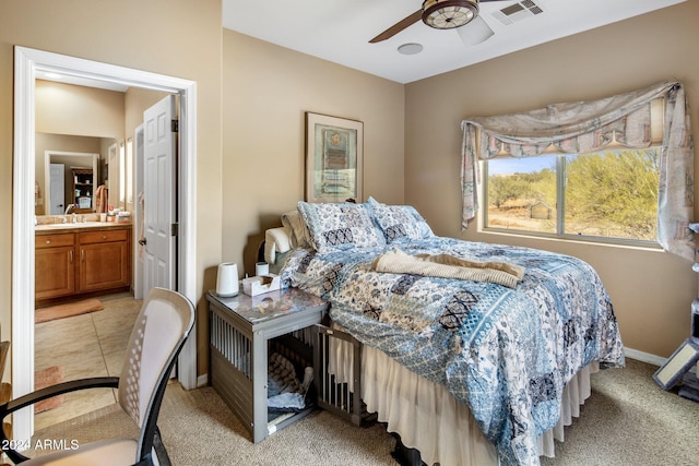 carpeted bedroom with ceiling fan, sink, and ensuite bath