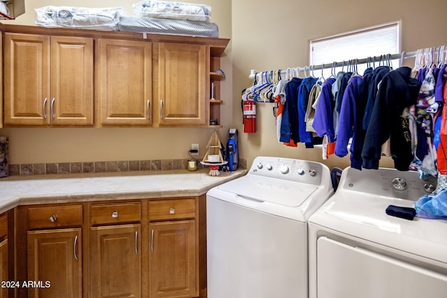 laundry room featuring cabinets and washer and dryer