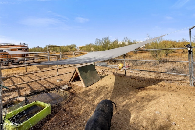 view of horse barn featuring a rural view