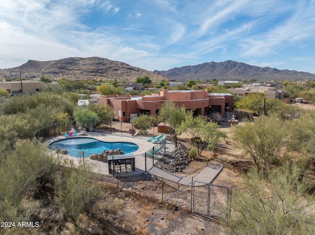 view of swimming pool featuring a mountain view and a patio