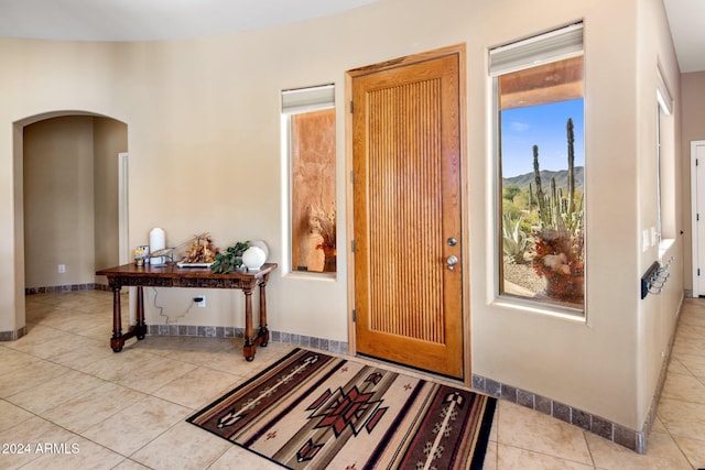 foyer entrance with a mountain view and light tile patterned flooring