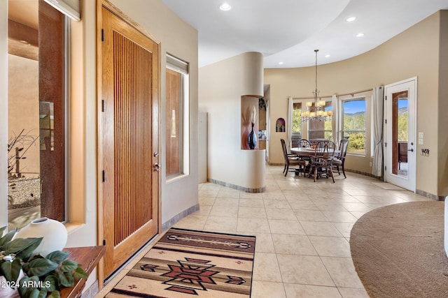 hall with light tile patterned floors and a chandelier