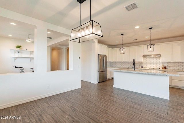 3023 W New River Dr, San Tan Valley, AZ 85144 - kitchen with freestanding refrigerator, tasteful backsplash, wood finished floors, visible vents, and white cabinets