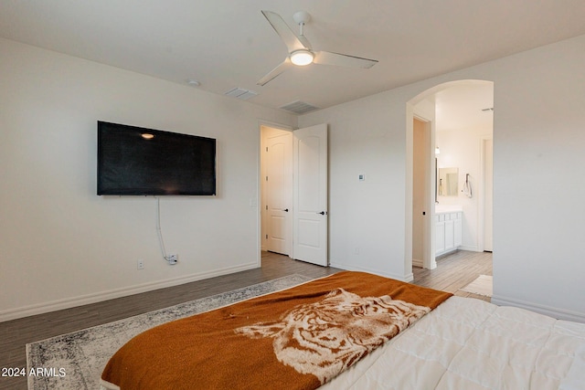 3023 W New River Dr, San Tan Valley, AZ 85144 - bedroom featuring visible vents, baseboards, ceiling fan, wood finished floors, and arched walkways