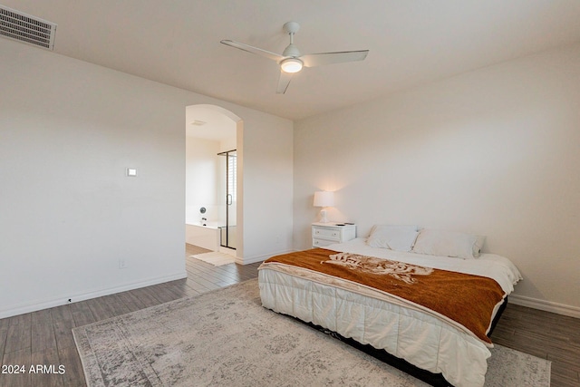 3023 W New River Dr, San Tan Valley, AZ 85144 - bedroom featuring wood finished floors, arched walkways, baseboards, and visible vents