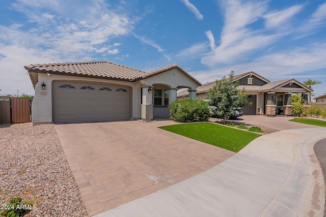 3023 W New River Dr, San Tan Valley, AZ 85144 - mediterranean / spanish home featuring stucco siding, a tile roof, a garage, and decorative driveway