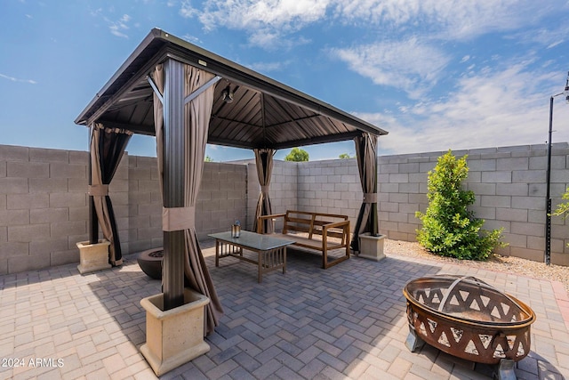 3023 W New River Dr, San Tan Valley, AZ 85144 - view of patio / terrace featuring an outdoor living space with a fire pit, a fenced backyard, and a gazebo
