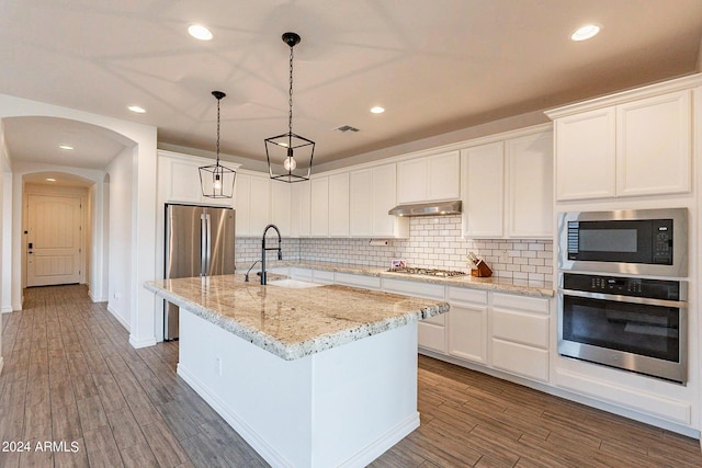 3023 W New River Dr, San Tan Valley, AZ 85144 - kitchen with visible vents, appliances with stainless steel finishes, under cabinet range hood, a sink, and dark wood-style floors