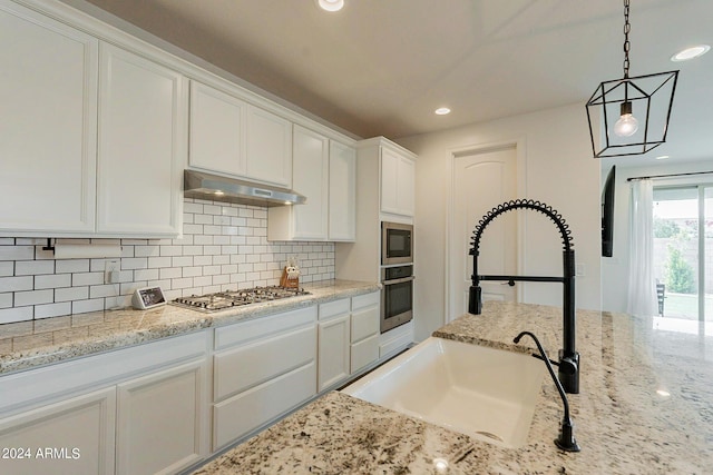 3023 W New River Dr, San Tan Valley, AZ 85144 - kitchen featuring decorative backsplash, stainless steel appliances, under cabinet range hood, white cabinetry, and a sink