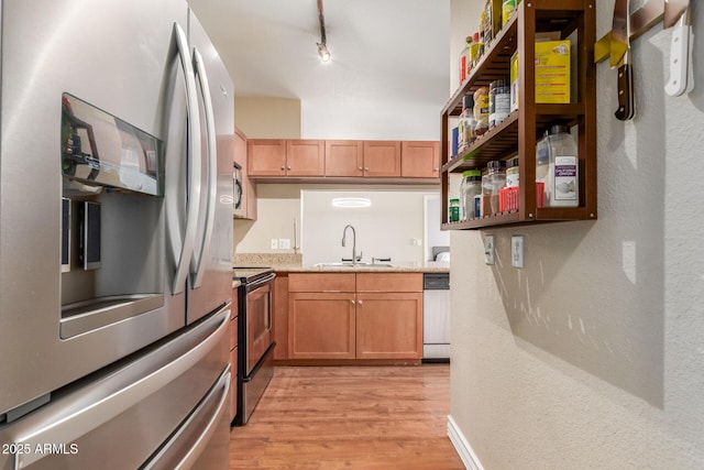 5345 E Van Buren St Unit 258, Phoenix, AZ 85008 - kitchen featuring light wood-type flooring, a sink, light stone counters, track lighting, and appliances with stainless steel finishes