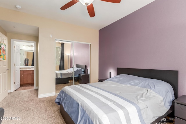 5345 E Van Buren St Unit 258, Phoenix, AZ 85008 - bedroom with a closet, ensuite bathroom, baseboards, ceiling fan, and light colored carpet