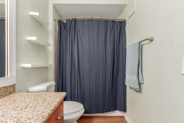 5345 E Van Buren St Unit 258, Phoenix, AZ 85008 - full bathroom with a shower with curtain, toilet, and wood finished floors