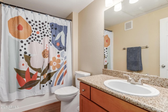 5345 E Van Buren St Unit 258, Phoenix, AZ 85008 - full bathroom with visible vents, toilet, vanity, and wood finished floors