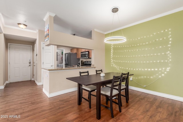5345 E Van Buren St Unit 258, Phoenix, AZ 85008 - dining area with ornamental molding, dark wood-style floors, and baseboards