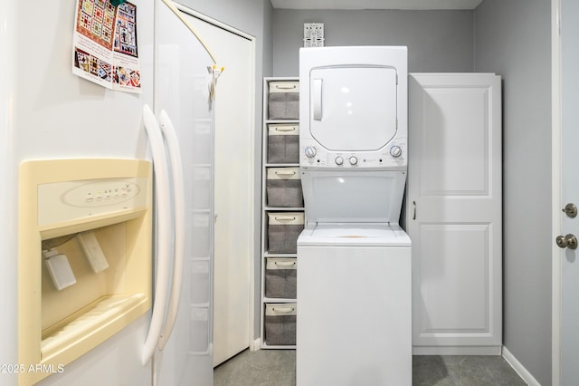 washroom featuring stacked washer and clothes dryer