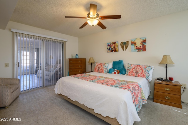 bedroom with ceiling fan, access to outside, light colored carpet, and a textured ceiling