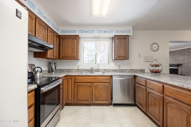1454 W Capri Ave, Mesa, AZ 85202 - kitchen featuring stainless steel appliances, under cabinet range hood, brown cabinets, and light tile patterned floors