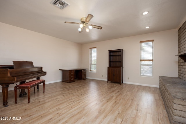 1454 W Capri Ave, Mesa, AZ 85202 - living room featuring a ceiling fan, light wood finished floors, a fireplace, and recessed lighting