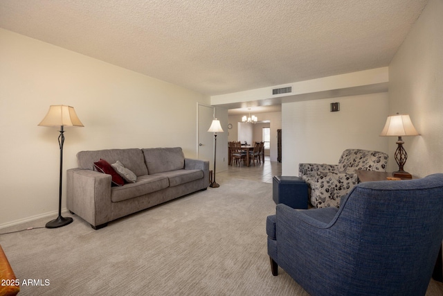 1454 W Capri Ave, Mesa, AZ 85202 - living area featuring a chandelier, a textured ceiling, and light colored carpet