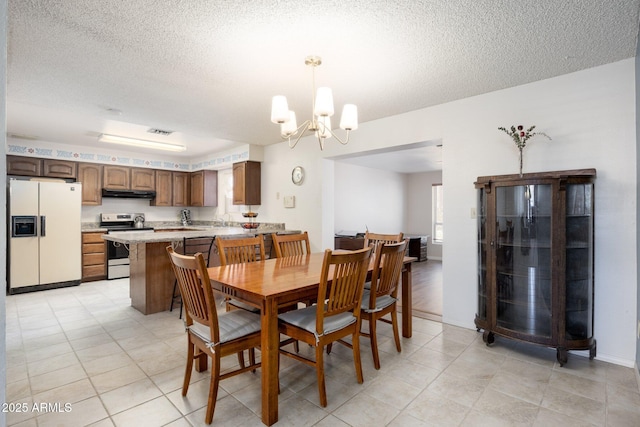 1454 W Capri Ave, Mesa, AZ 85202 - dining room featuring a chandelier and a textured ceiling