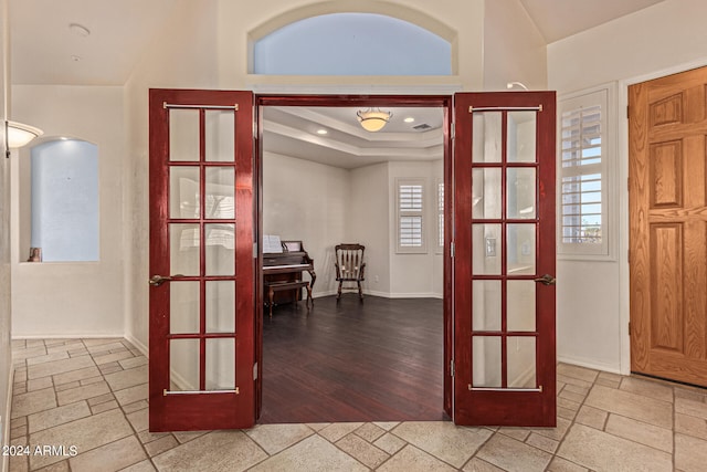 entrance foyer featuring french doors, light hardwood / wood-style flooring, and plenty of natural light