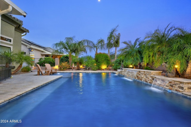 view of swimming pool featuring a patio area, fence, and a fenced in pool