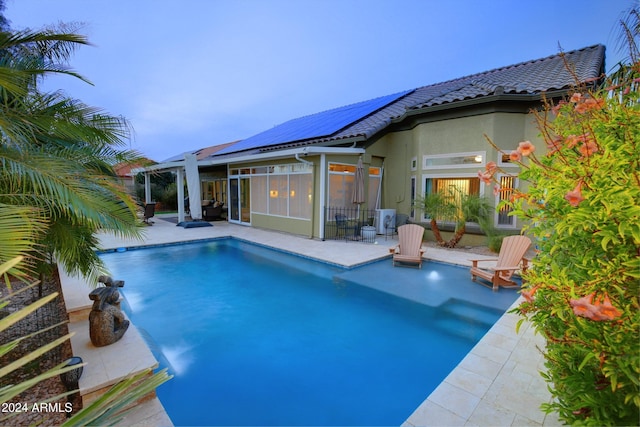 pool featuring a patio and a sunroom