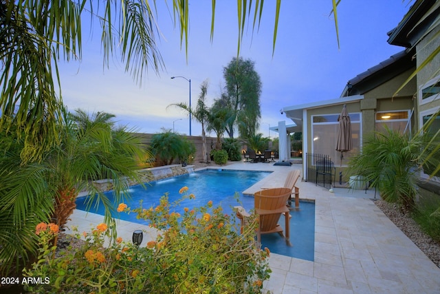 view of swimming pool with a patio area, fence, and a fenced in pool