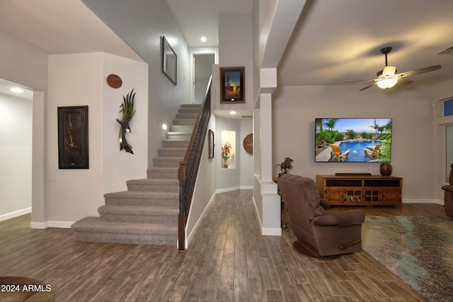 foyer entrance with ceiling fan, stairs, baseboards, and wood finished floors