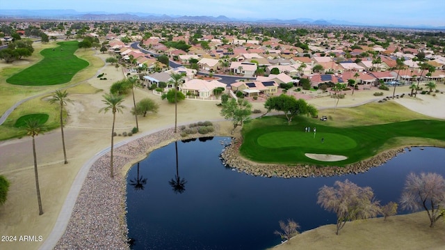 drone / aerial view featuring a residential view, golf course view, and a water and mountain view